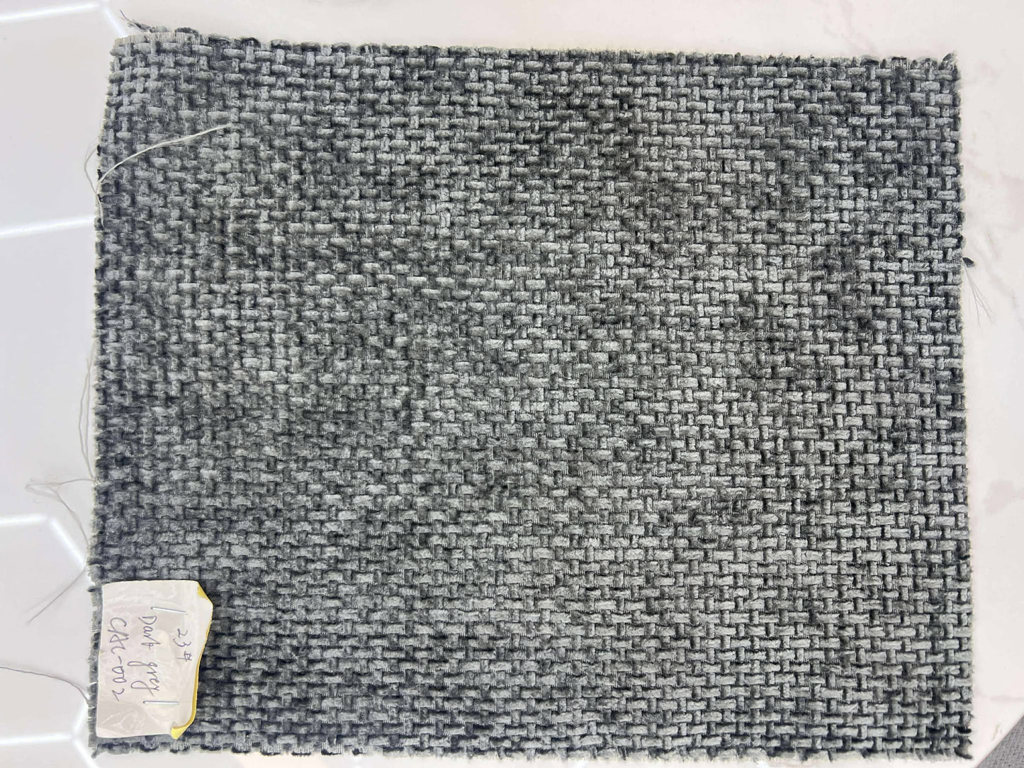 Gray textured fabric sample on a white background