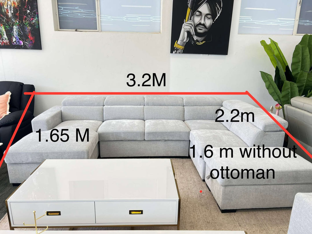 Gray sectional sofa with measurements in a living room setting